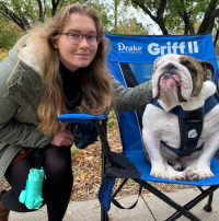 female rider with drake bulldog Griff in chair